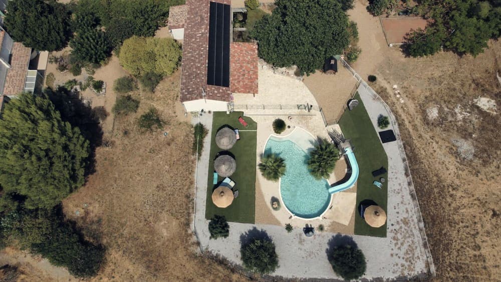 A round above-ground swimming pool in a garden