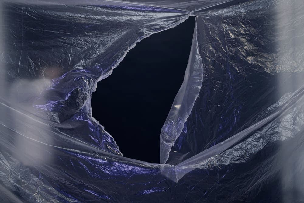 Rolled blue sheeting material photographed outdoors