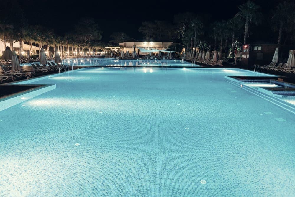 A lit swimming pool at night