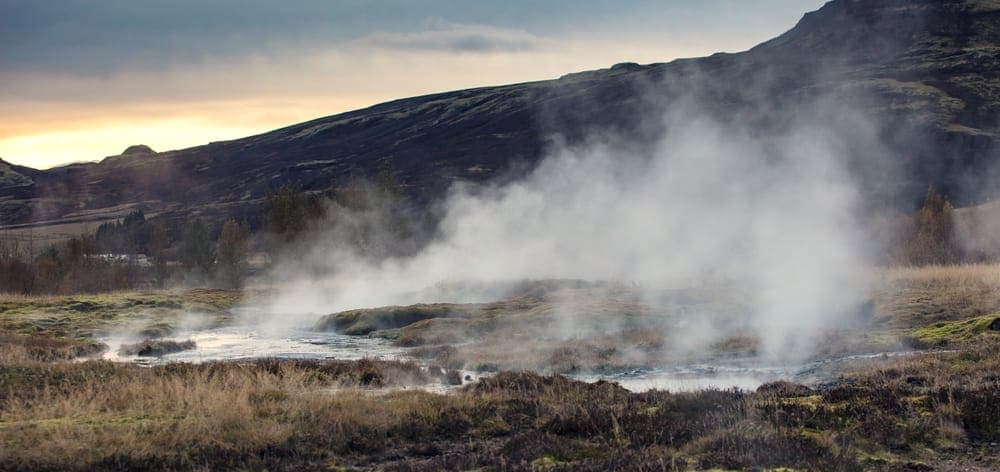 Steam rising from warm water into cold air